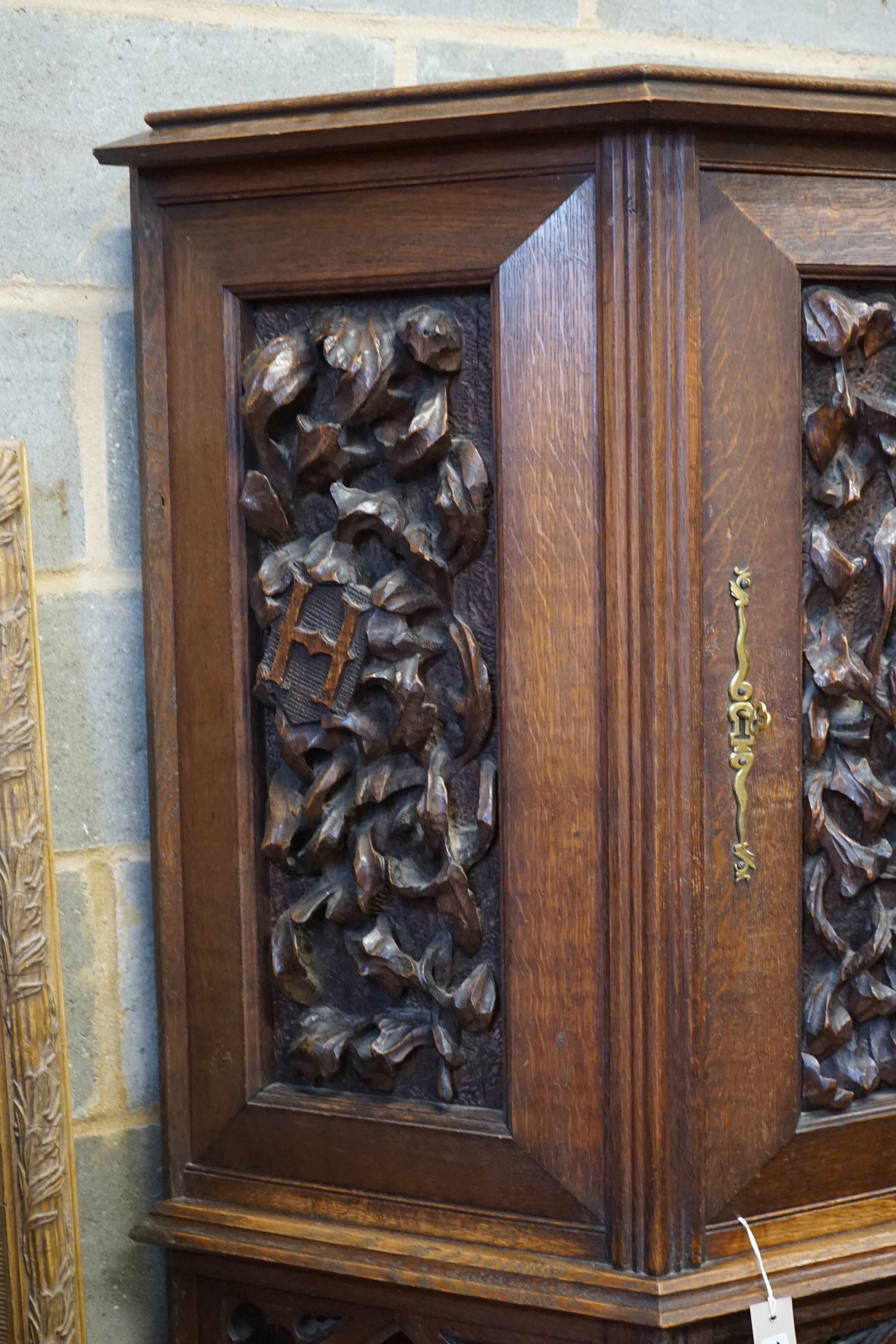 An early 20th century Gothic style carved oak sided cabinet, width 118cm, depth 36cm, height 176cm